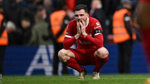 Andy Robertson crouches down and puts his hands on his face in shock at full-time after Liverpool's 1-0 defeat to Crystal Palace